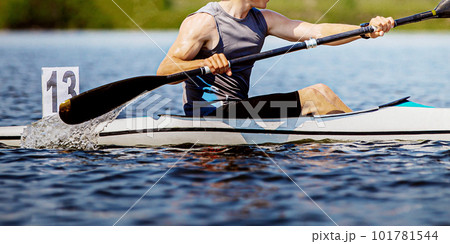 close-up kayaker athlete on kayak single in kayaking championship race, boat number 13 101781544