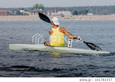 rear view male athlete on kayak single in kayaking competition race, sports summer games rear view male athlete on kayak single in kayaking competition race, sports summer games 101781557