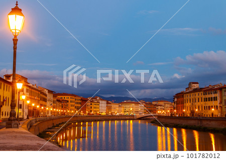Panoramic view of the old town of Pisa and the Arno river at twilight, Italy. Night cityscape 101782012