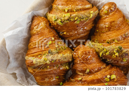 French croissants in wicker basket on table 101783829