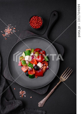Delicious, fresh Greek salad with feta cheese, olives, tomatoes and cucumbers 101784094
