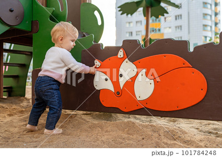 Adorable little girl playing on the playground	 101784248