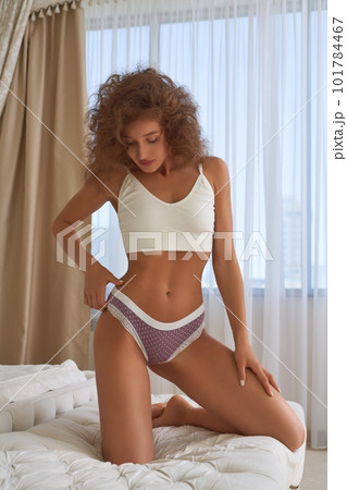 Young woman in sportive bra and underwear in bedroom 101784467