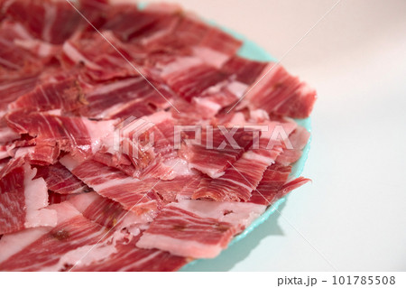 plate with sliced serrano jamon 101785508