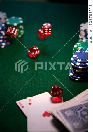 dice chips on green cloth for poker 101785513