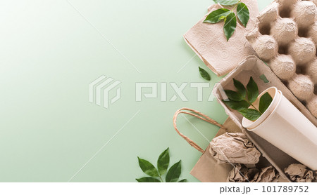 World environment Day, go green, recycle, earth day and eco concept, Different paper garbage materials and plant on pastel background.. World environment Day, go green, recycle, earth day and eco concept, Different paper garbage materials and plant on pastel background.. 101789752