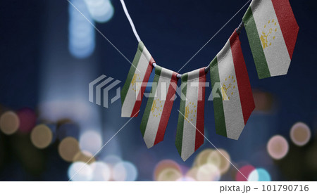A garland of Tajikistan national flags on an abstract blurred background A garland of Tajikistan national flags on an abstract blurred background 101790716
