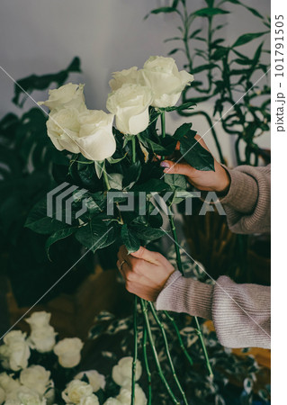 Small business flower shop florist hands preparing a bouquet Small business flower shop florist hands preparing a bouquet 101791505