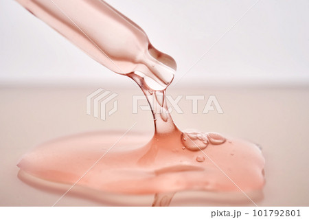 Pipette with a viscous pink cosmetic close-up. 101792801