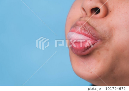 Young woman chewing gum and blowing bubble gum on blue background. 101794672
