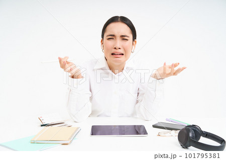Sad japanese office manager, woman screaming and shouting, stressed out on work, sits in office with distressed emotions, white background 101795381