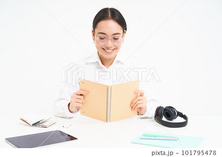 Image of hardworking student, asian woman in glasses studying, holding notebook, working on project, isolated over white background 101795478