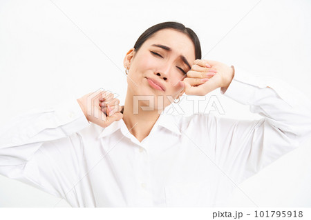 Exhausted business woman stretches hands and looks tired, stands with fatigue over white studio background Exhausted business woman stretches hands and looks tired, stands with fatigue over white studio background 101795918