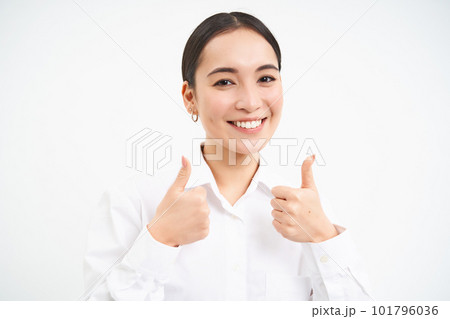Portrait of asian businesswoman shows thumbs up, approves smth, recommends company, stands over white background Portrait of asian businesswoman shows thumbs up, approves smth, recommends company, stands over white background 101796036