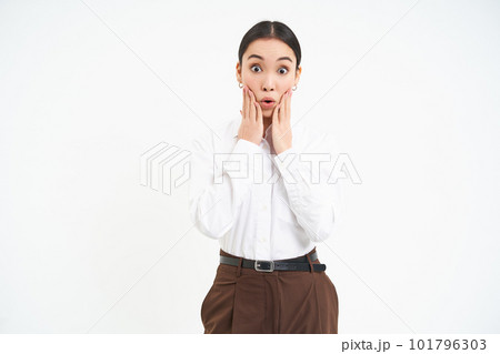 Corporate woman looks amazed, holds hands near face with surprised face expression, isolated on white background Corporate woman looks amazed, holds hands near face with surprised face expression, isolated on white background 101796303