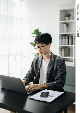Young business man executive manager looking at laptop watching online webinar training or having virtual meeting video conference doing market research working in office... 101797295