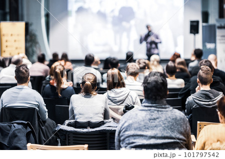 Speaker giving a talk in conference hall at business event. Audience at the conference hall. Business and Entrepreneurship concept. Focus on unrecognizable people in audience. Speaker giving a talk in conference hall at business event. Audience at the conference hall. Business and Entrepreneurship concept. Focus on unrecognizable people in audience. 101797542
