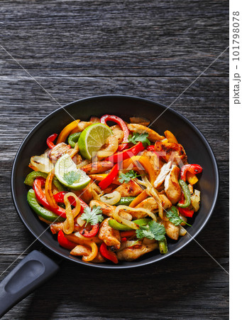 chicken fajitas with bell peppers, onion, spices 101798078