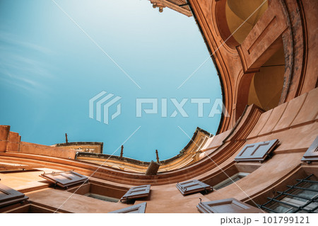 Bottom up view amazing old building tenement houses in italy with rounded swirling shape overlooking blue clear sky on a sunny warm summer day. Concept of a unique architectural heritage. Copyspace Bottom up view amazing old building tenement houses in italy with rounded swirling shape overlooking blue clear sky on a sunny warm summer day. Concept of a unique architectural heritage. Copyspace 101799121