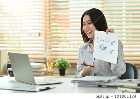Beautiful young female investment advisor having video call, giving online consultation to client on internet 101801124