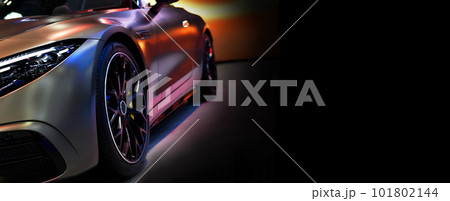 Front headlights of sport roadster car on black background,copy space 101802144