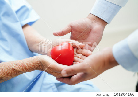 Asian woman doctor holding red heart for health in hospital. 101804166