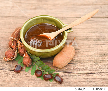 Tamarind set for health & Beauty treatment spa, hair, skin scrub,  Tamarind ripe peel shell, seeds in wood spoon in chopboard place on wooden background. 101805844