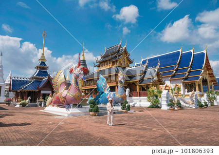 Asian female tourist come to worship at Wat Ban Den or Wat Den Salee Sri Muang Gan the Lanna style temple and colorful statue sculpture at Chiang Mai 101806393