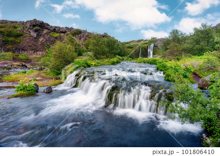 Gjain waterfall flowing with lush jungle in Pjorsardalur valley on summer at Iceland 101806410