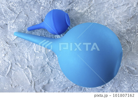Small and large blue syringes, enemas, pears. Close-up. 101807162