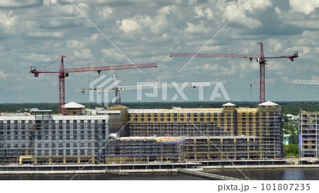 Tower cranes and frame structure of high residential apartment buildings at construction site. Real estate development Tower cranes and frame structure of high residential apartment buildings at construction site. Real estate development 101807235