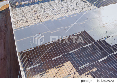 Installing metal construction frame for steel warehouse work on construction site 101808928