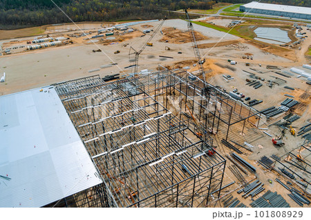 During installation metal frame for steel warehouse construction frame to working large cranes in construction site 101808929