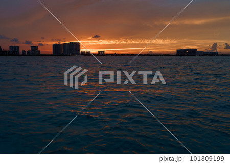 Sunrise or sunrise overlooking the sea and a line of hotels in Cancun Sunrise or sunrise overlooking the sea and a line of hotels in Cancun 101809199