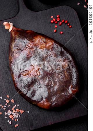 Tasty mahan, prosciutto or jamon on a wooden cutting board 101809404