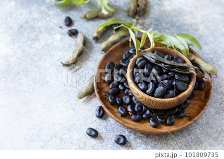 Organic food.  The concept of vegan or diet food. Fresh ripe black soy beans on a stone background. Copy space. 101809735
