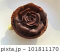 A chocolate rose, sprinkled with fine cacao powder, against a beige background. A chocolate rose, sprinkled with fine cacao powder, against a beige background. 101811170