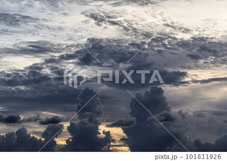 Dark clouds obscure a colorful sunset. 101811926