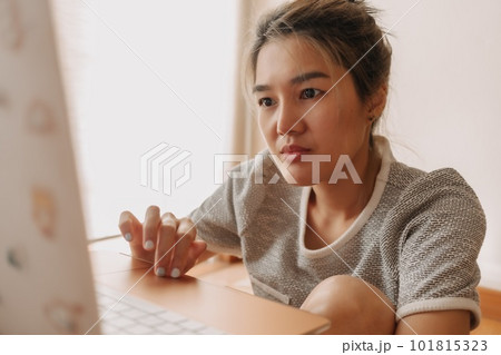 Serious woman working with her laptop in the bedroom. Serious woman working with her laptop in the bedroom. 101815323