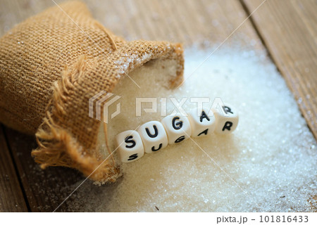 white sugar for food and sweets dessert candy heap of sweet sugar crystalline granulated, Sugar on sack and wooden background white sugar for food and sweets dessert candy heap of sweet sugar crystalline granulated, Sugar on sack and wooden background 101816433