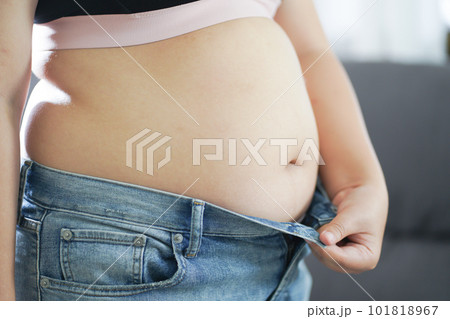 Mothercare. Pregnant woman measuring her belly growth of the baby. Healthy motherhood Body care pregnancy diet concept. Mothercare. Pregnant woman measuring her belly growth of the baby. Healthy motherhood Body care pregnancy diet concept. 101818967