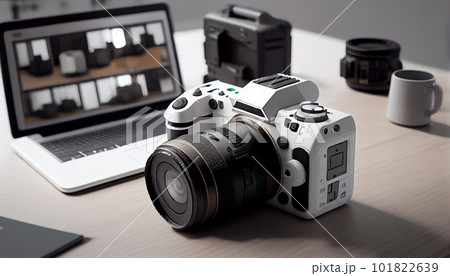 Photographer's workplace with a modern equipment. Mirrorless camera, laptop and prime lenses. 101822639