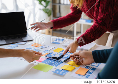 Creative team web designer planning application development for web mobile phone at modern workplace. Creative team web designer planning application development for web mobile phone at modern workplace. 101828076