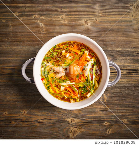 Rooster soup with smoked quail egg 101829009