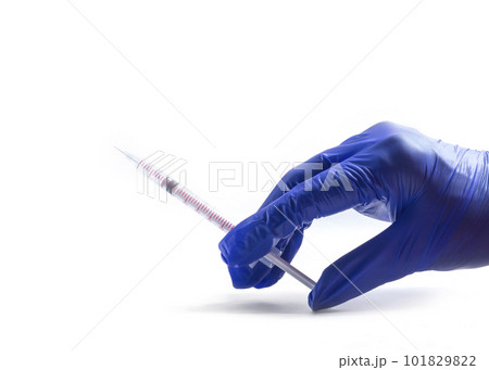 Hand in blue glove holding a syringe, isolated on white background. Health and medical concepts. COVID Hand in blue glove holding a syringe, isolated on white background. Health and medical concepts. COVID 101829822