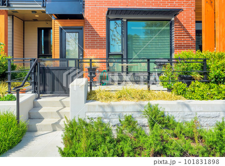 Small patio with BBQ in front of private entrance to a residential unit 101831898