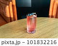 Summer cocktail garnished with blueberry berries. Pink cold beverage on bar terrace. 101832216