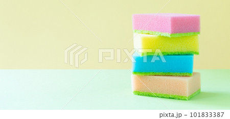 Cleaning concept - colorful dishwashing sponges on bright background Cleaning concept - colorful dishwashing sponges on bright background 101833387