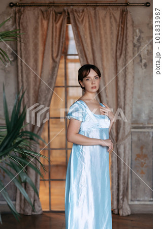A young beautiful girl in a Regency blue dress A young beautiful girl in a Regency blue dress 101833987