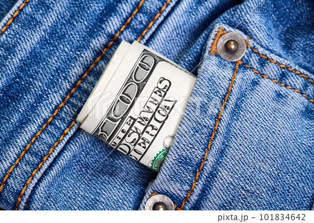 Rolled up one hundred dollar bills in jeans pocket Rolled up one hundred dollar bills in jeans pocket 101834642